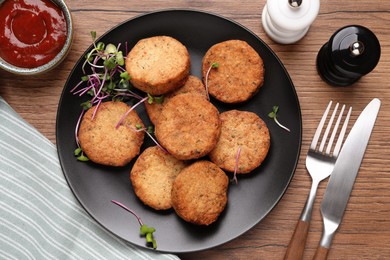 Delicious vegan cutlets served on wooden table, flat lay