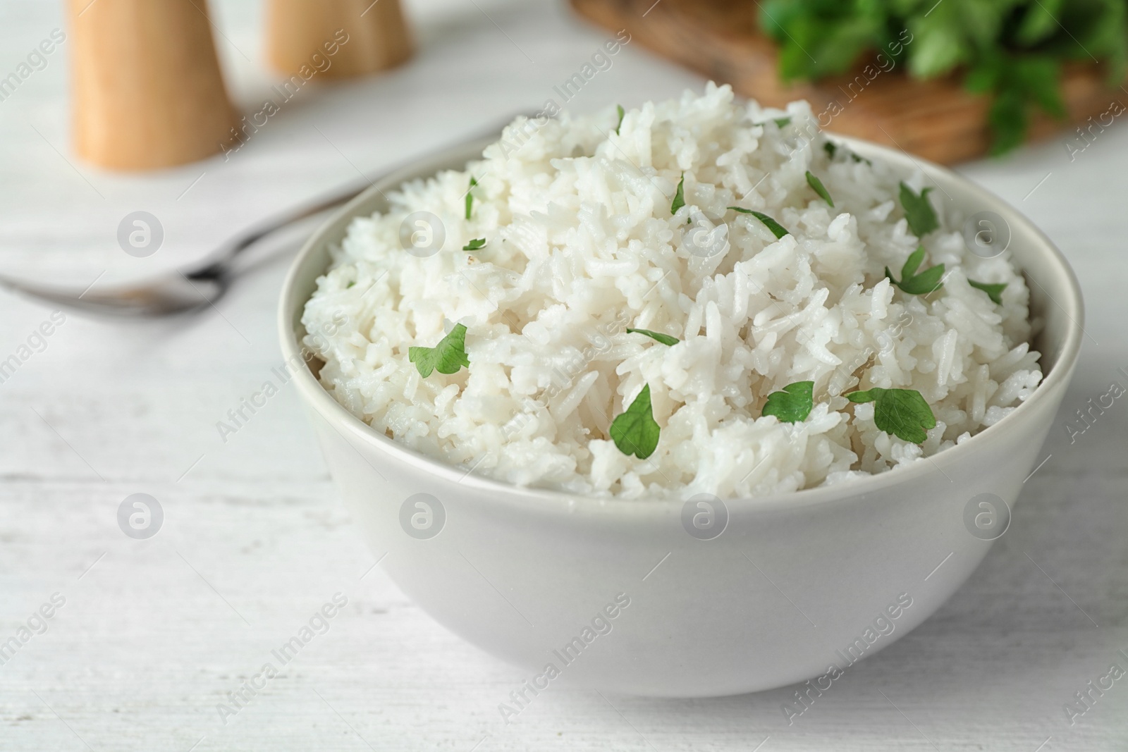 Photo of Bowl of boiled rice on table, closeup