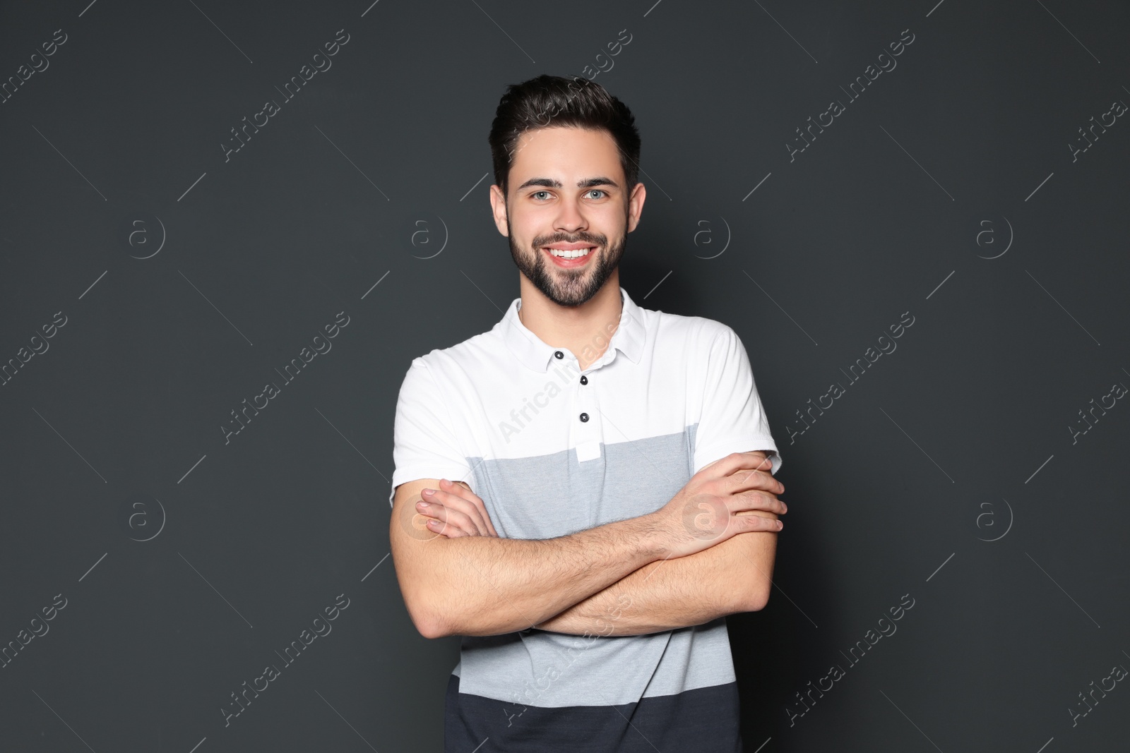 Photo of Portrait of handsome man smiling on grey background