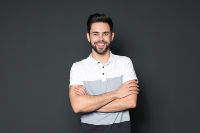 Photo of Portrait of handsome man smiling on grey background