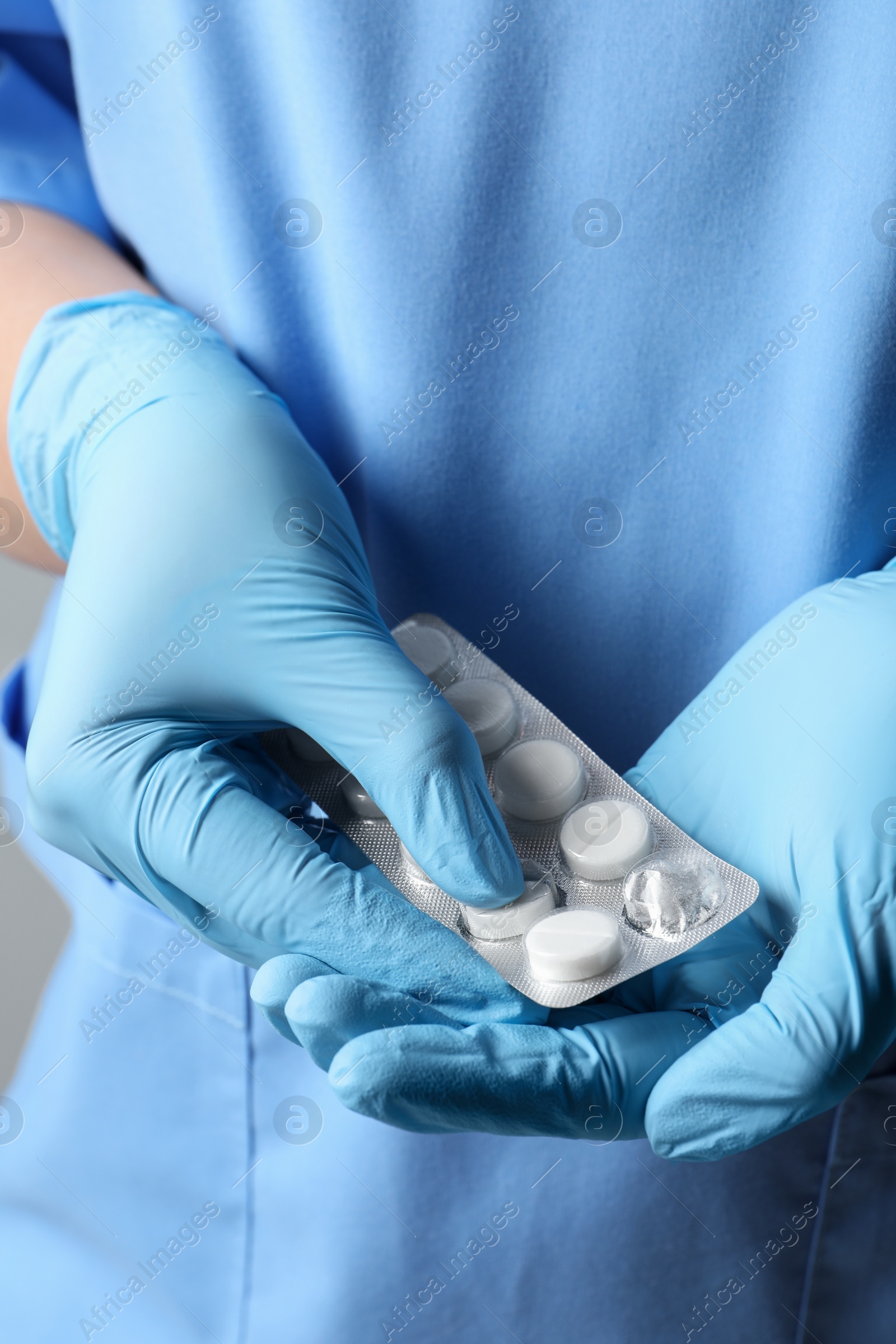 Photo of Doctor taking pill out from blister pack, closeup