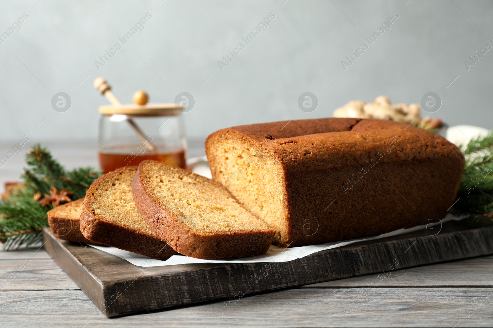 Photo of Fresh sliced gingerbread cake on wooden table