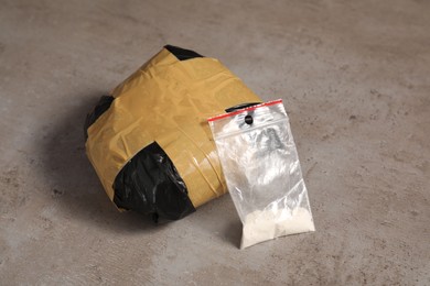 Packages with narcotics on grey textured table