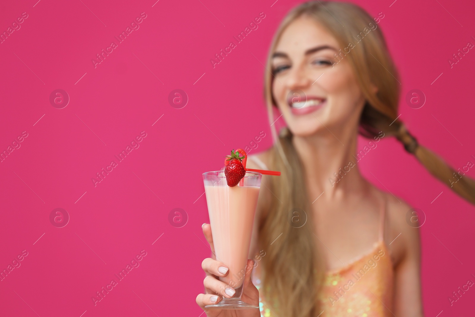 Photo of Young woman with glass of delicious milk shake on color background