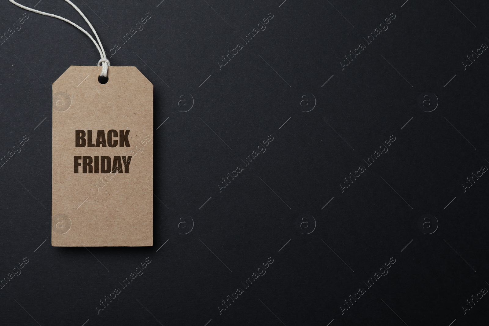 Photo of Tag with words Black Friday on dark background, top view. Space for text