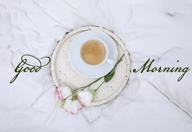 Good morning! Tray with cup of coffee and flowers on white bedsheet, top view