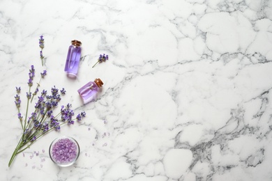 Photo of Flat lay composition with natural cosmetic products and lavender flowers on marble background. Space for text