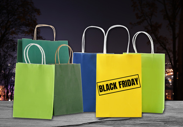 Image of Black Friday. Many shopping bags on blurred background