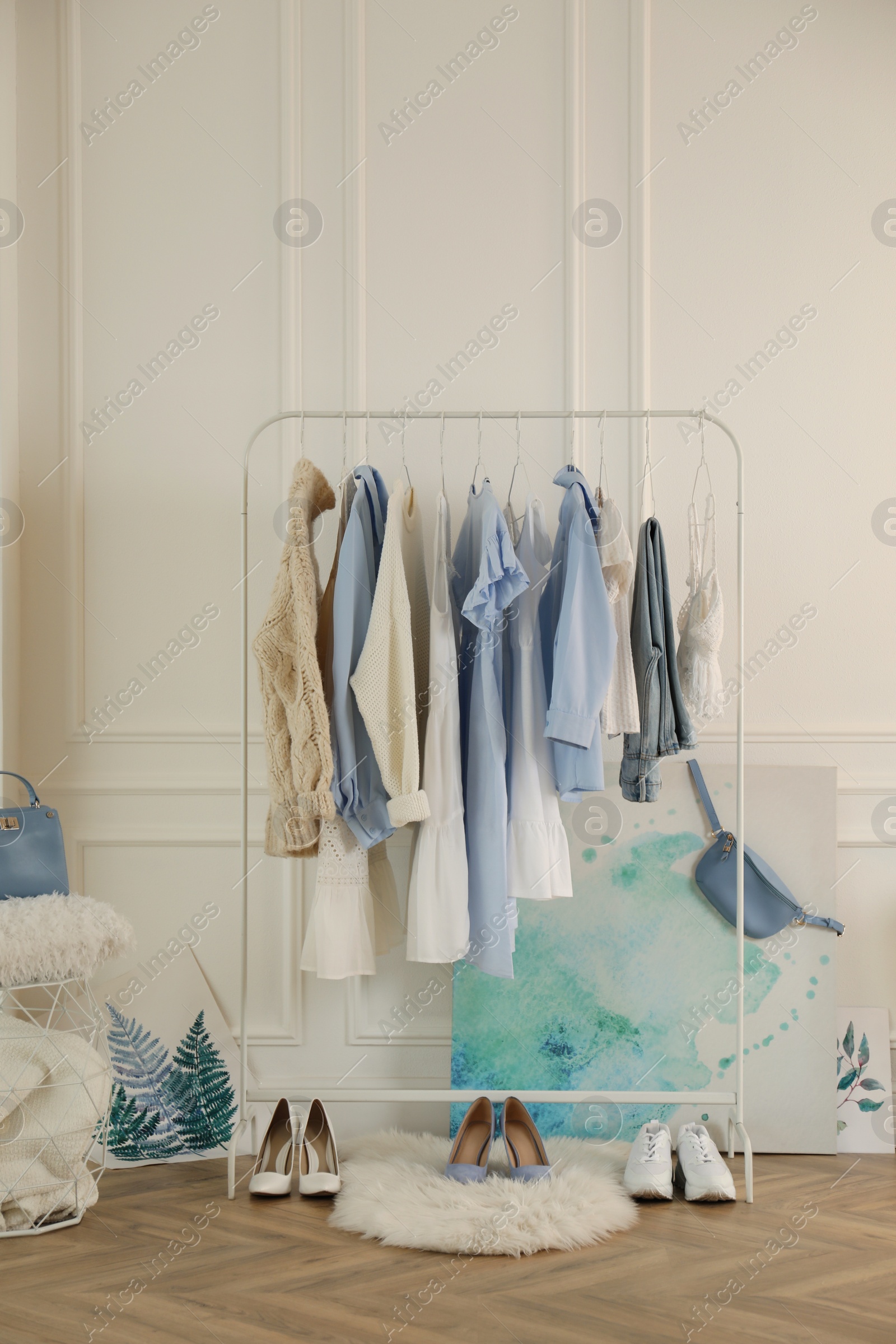 Photo of Rack with stylish clothes in modern dressing room