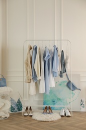 Rack with stylish clothes in modern dressing room