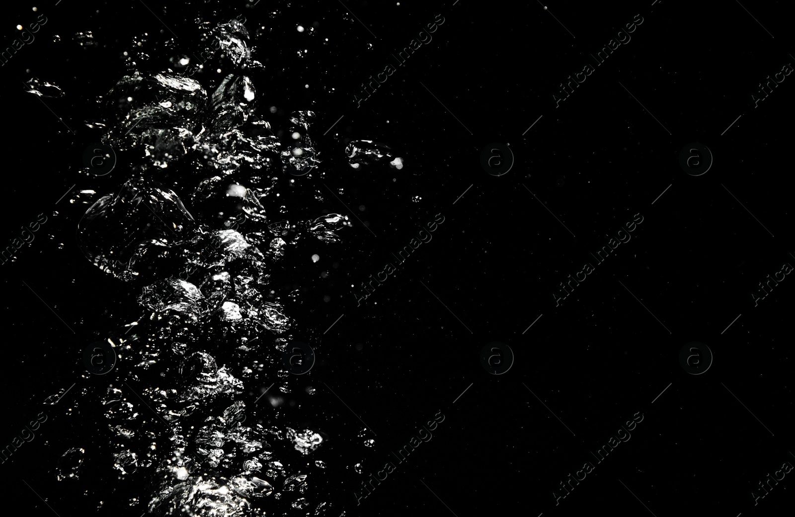 Image of Many air bubbles in water on black background, space for text