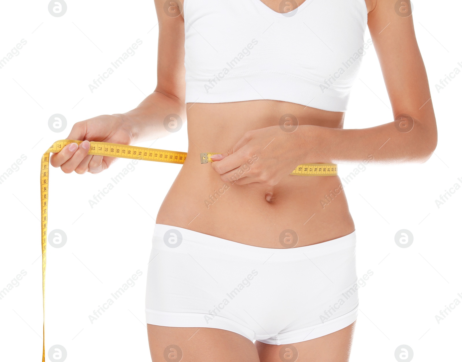 Photo of Young slim woman in underwear with measuring tape on white background. Weight loss diet