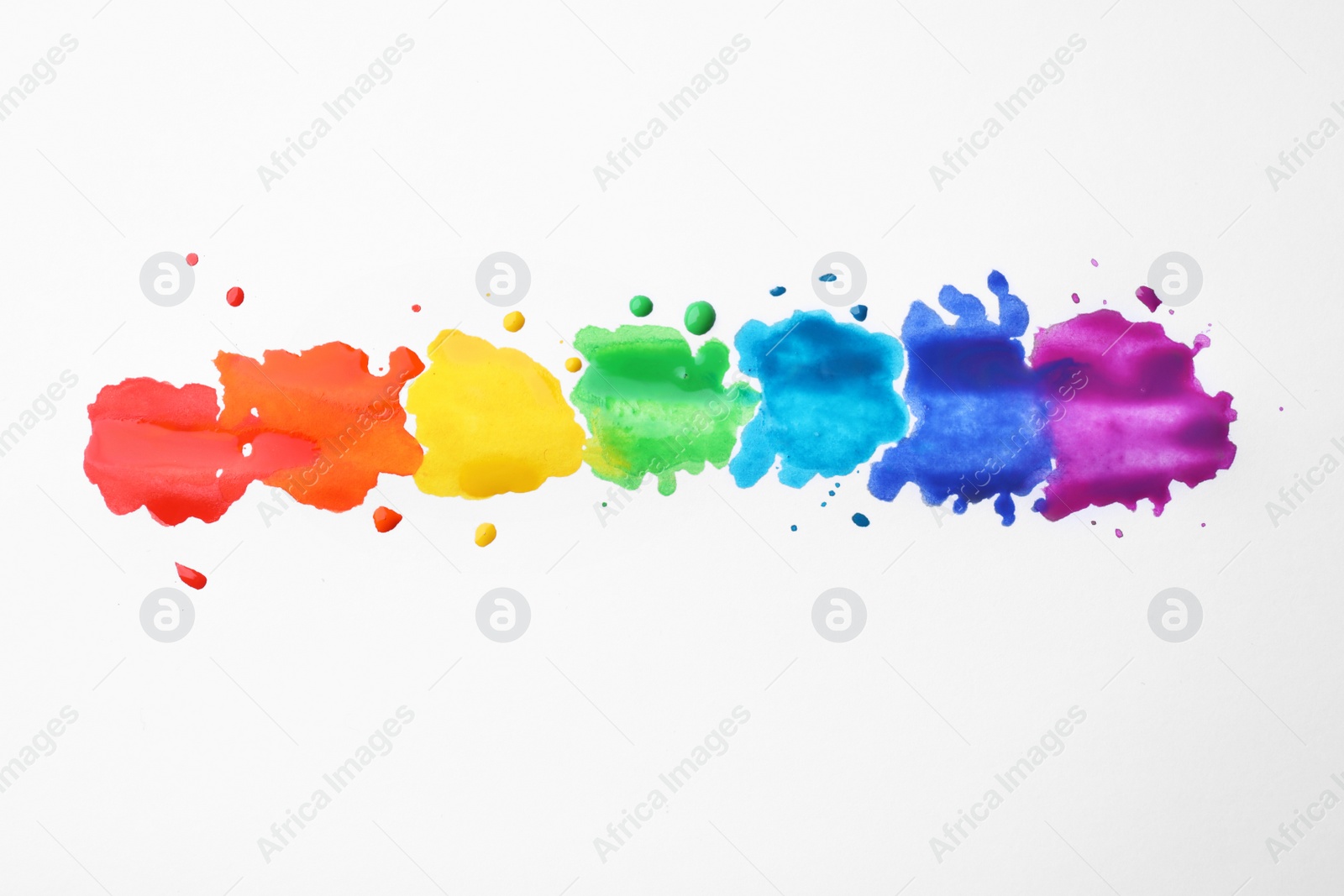 Photo of Rainbow drawing with watercolor paint on white paper, top view