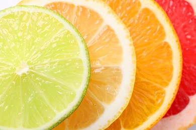 Photo of Slices of fresh ripe citrus fruits as background, top view