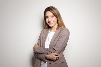 Portrait of young woman with beautiful face on light background