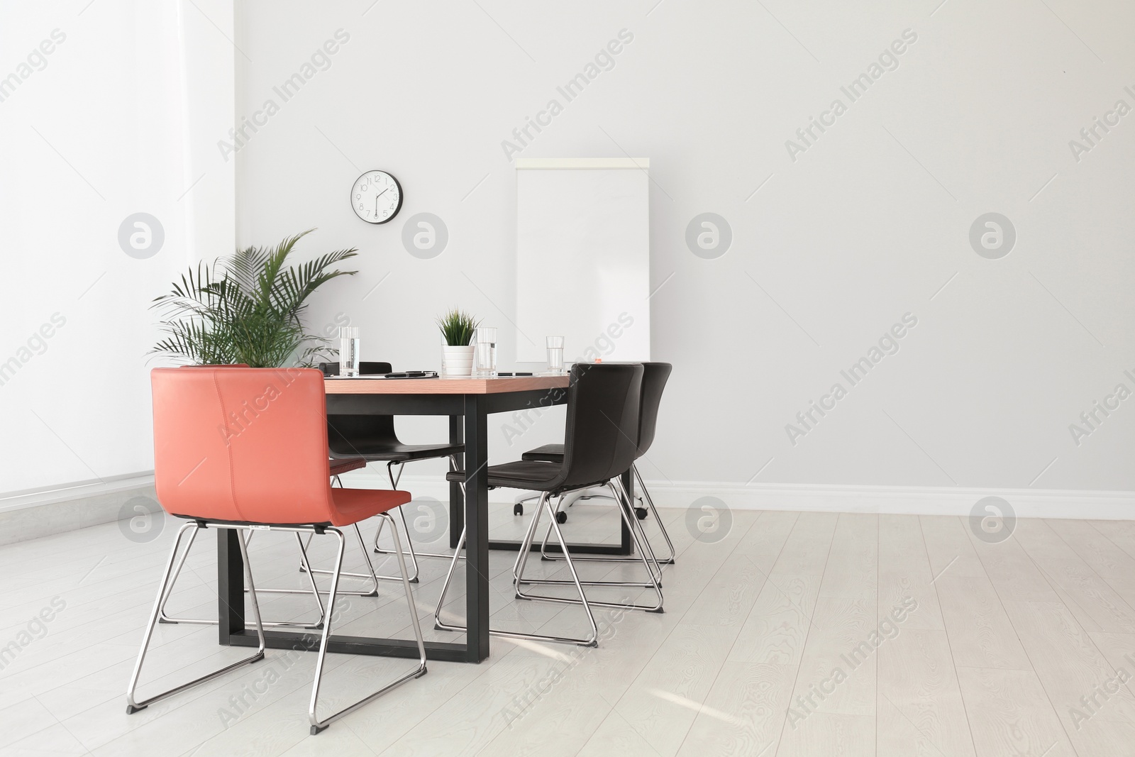 Photo of Simple office interior with large table and chairs