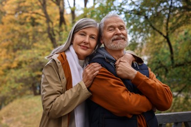 Portrait of affectionate senior couple in autumn park