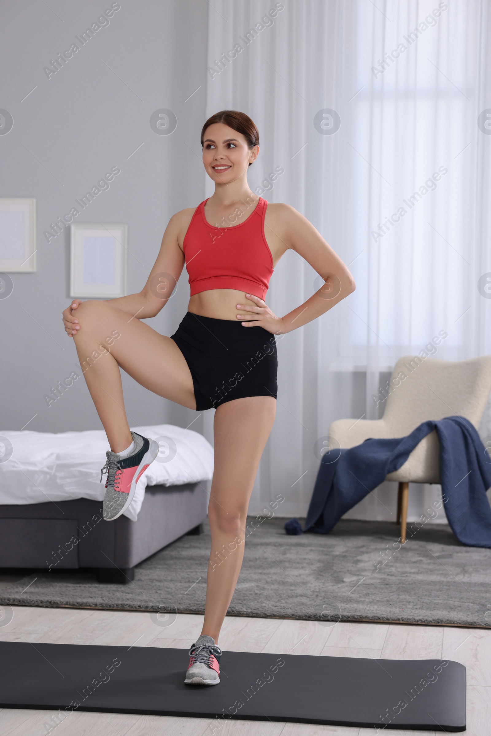 Photo of Happy woman doing morning exercise at home