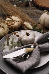Photo of Festive table setting with autumn decor on wooden desk, closeup