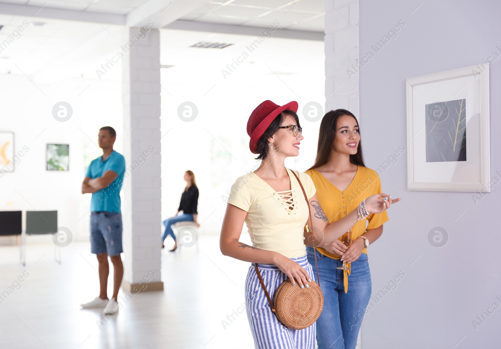 Photo of Young women at exhibition in art gallery