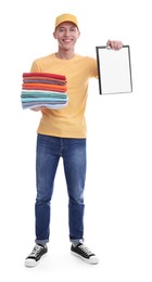 Dry-cleaning delivery. Happy courier holding folded clothes and clipboard on white background