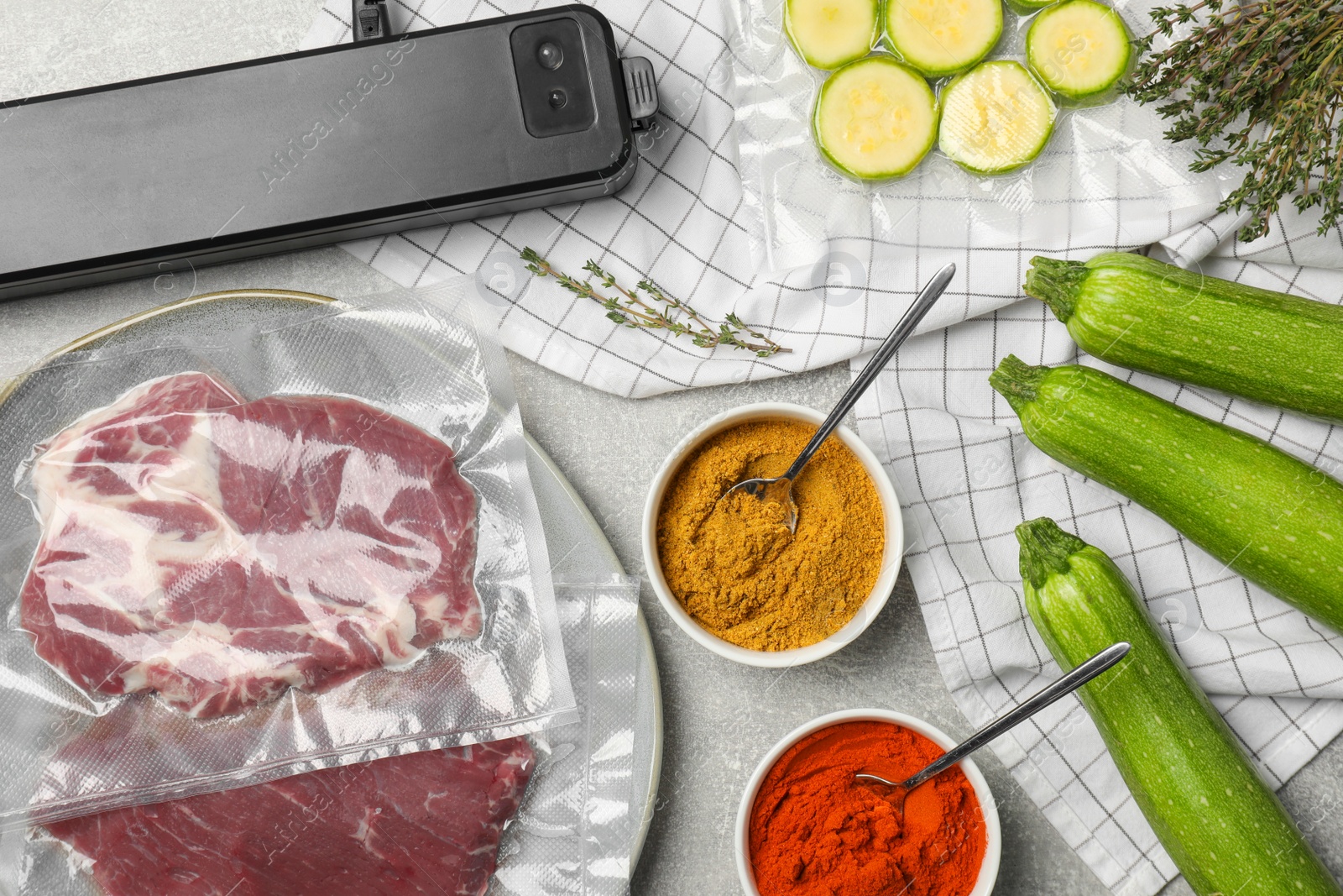 Photo of Flat lay composition of different food, spices and sealer for vacuum packing on table