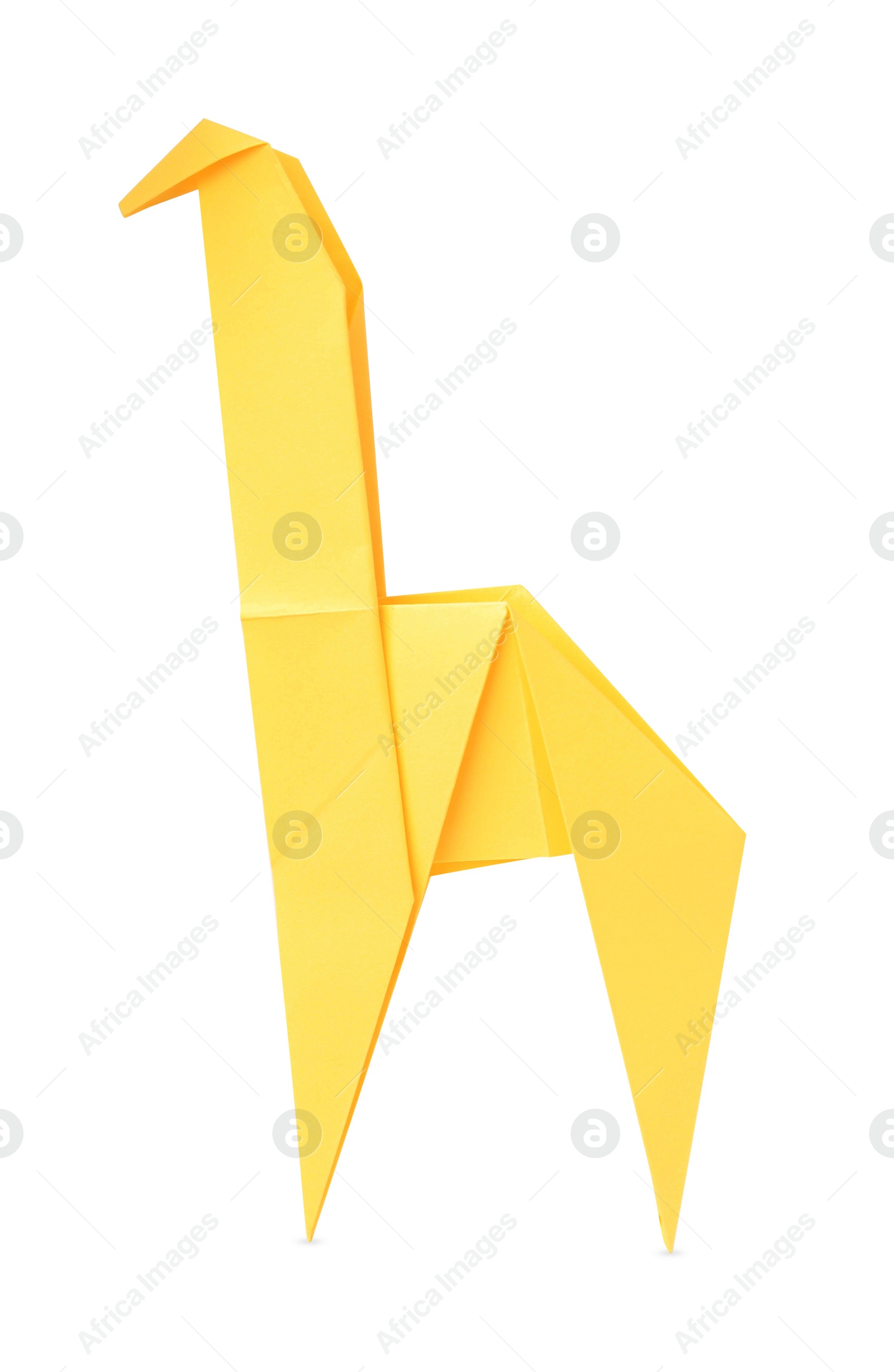 Photo of Origami art. Handmade yellow paper giraffe isolated on white