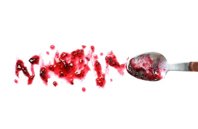 Photo of Spoon and sweet berry jam on white background