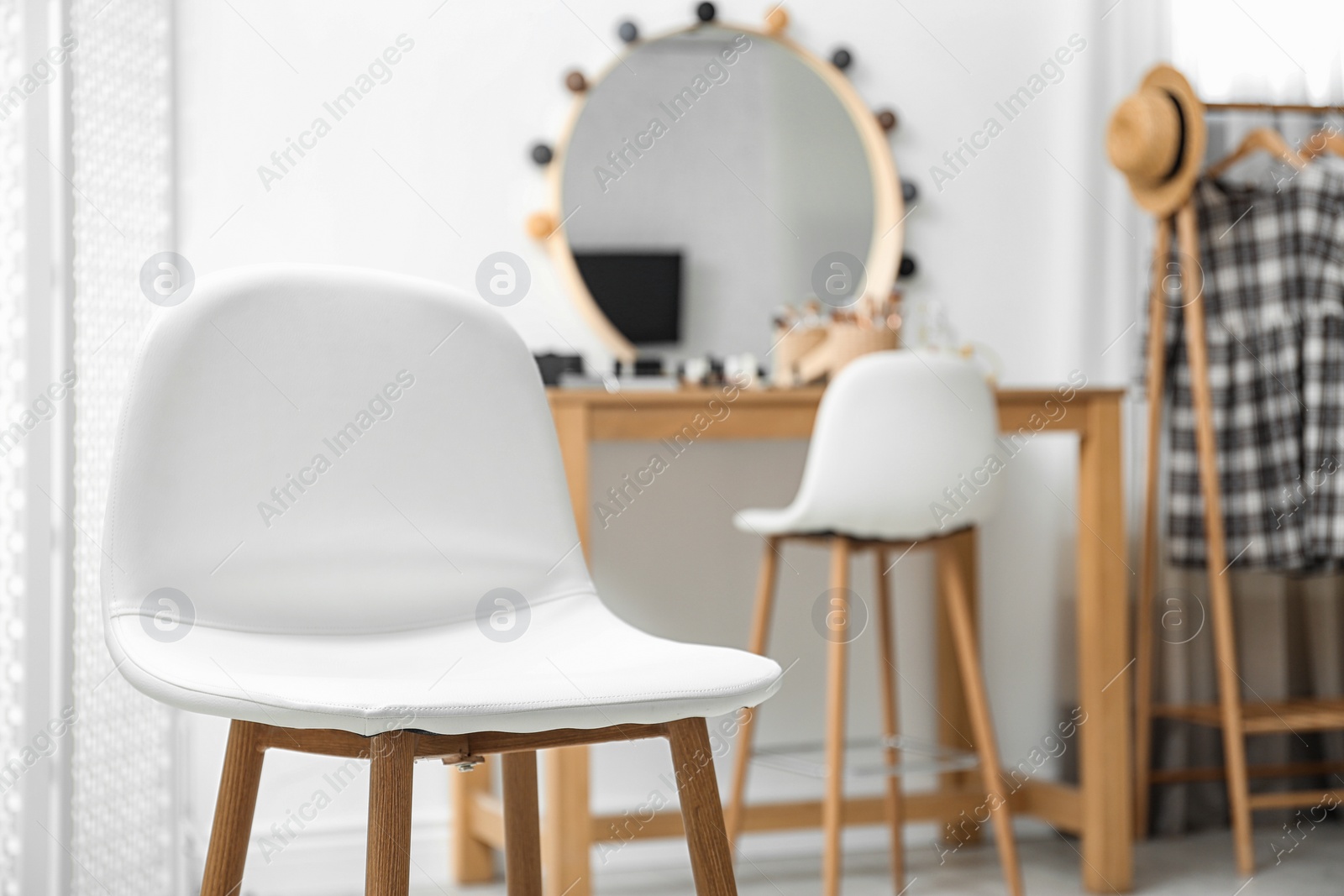 Photo of Stylish white chair in makeup room interior. Space for text