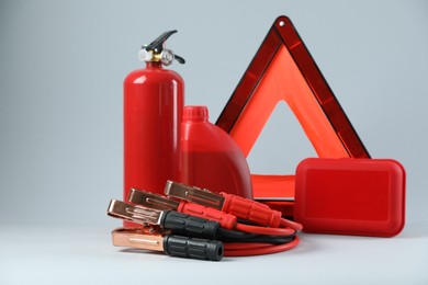 Photo of Set of car safety equipment on light grey background