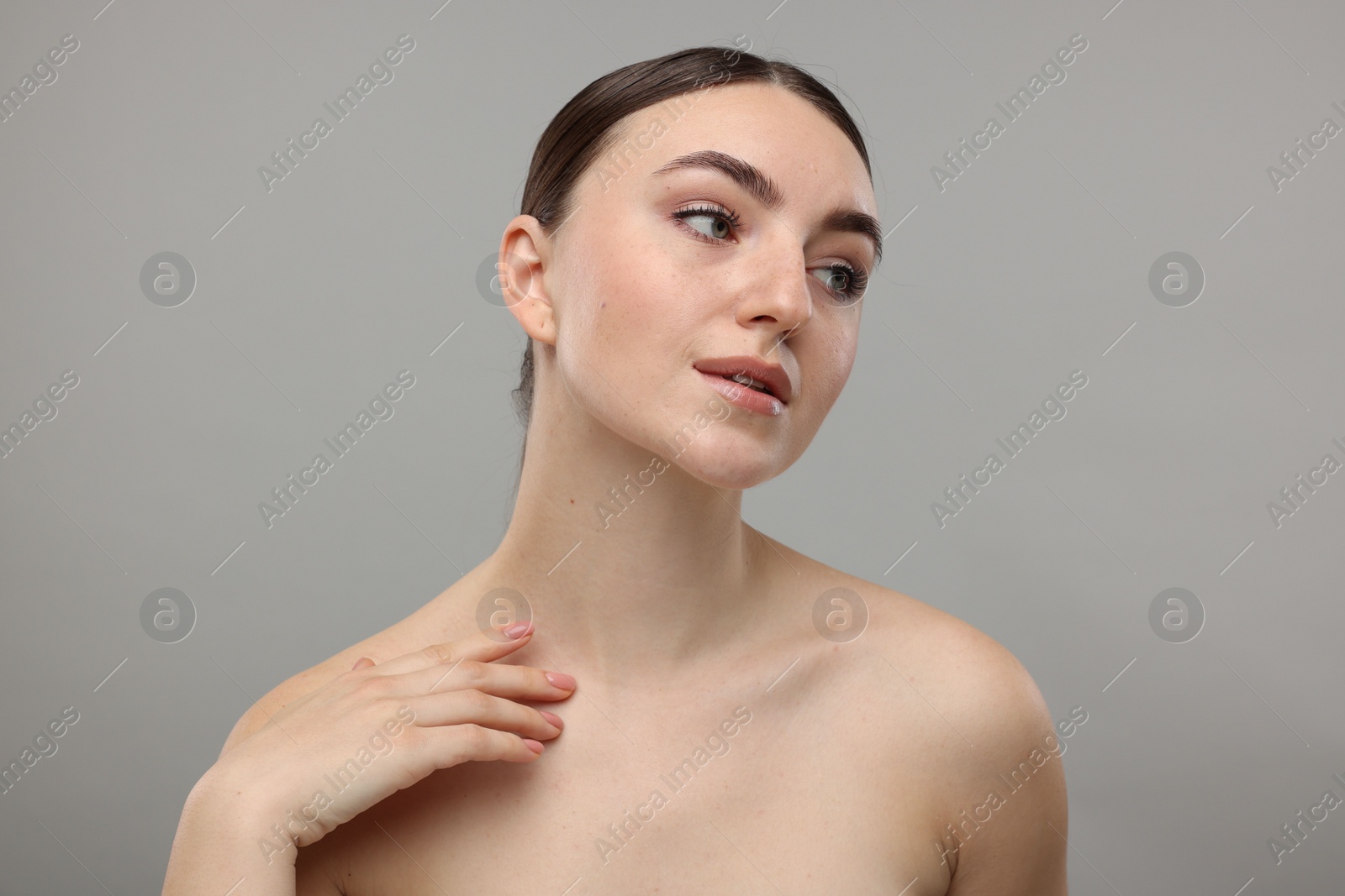 Photo of Portrait of beautiful woman on grey background