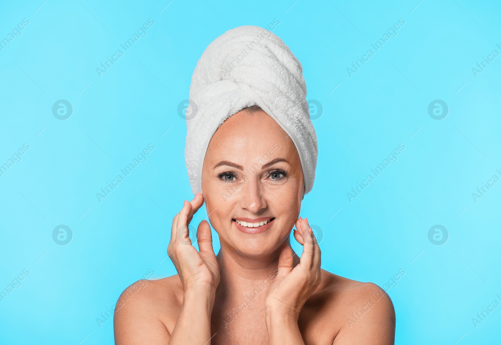 Photo of Portrait of beautiful mature woman with perfect skin on light blue background