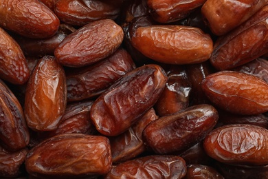 Photo of Sweet dried date fruits as background, top view