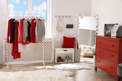 Dressing room with stylish clothes, shoes and accessories. Elegant interior design