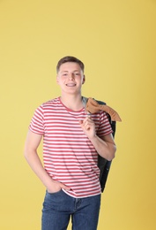 Photo of Portrait of teenage boy on yellow background