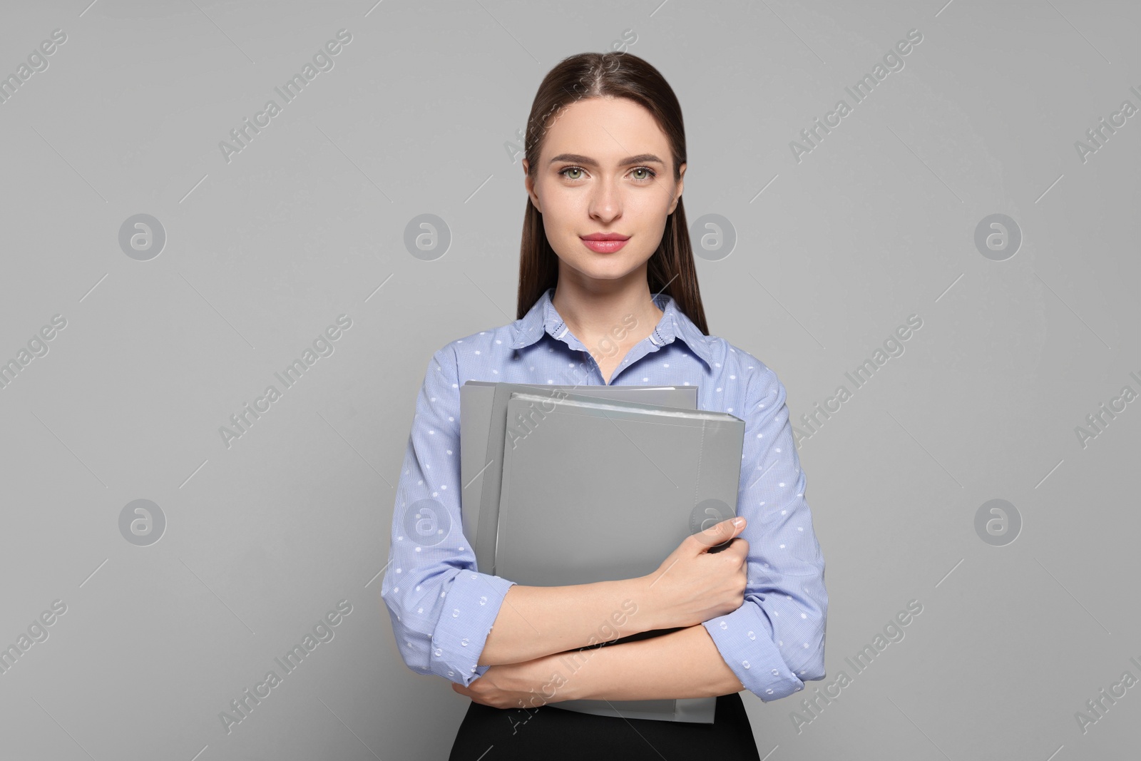 Photo of Portrait of beautiful young teacher on grey background