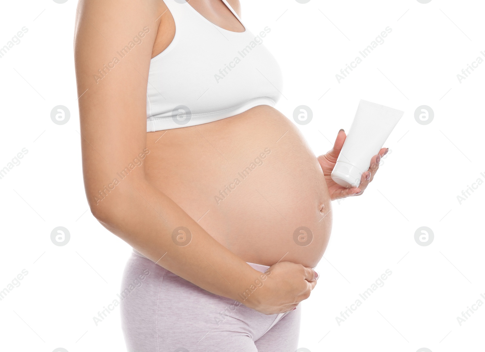 Photo of Pregnant woman holding body cream on white background, closeup