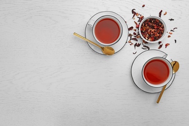 Photo of Composition with hibiscus tea on white wooden background, flat lay. Space for text