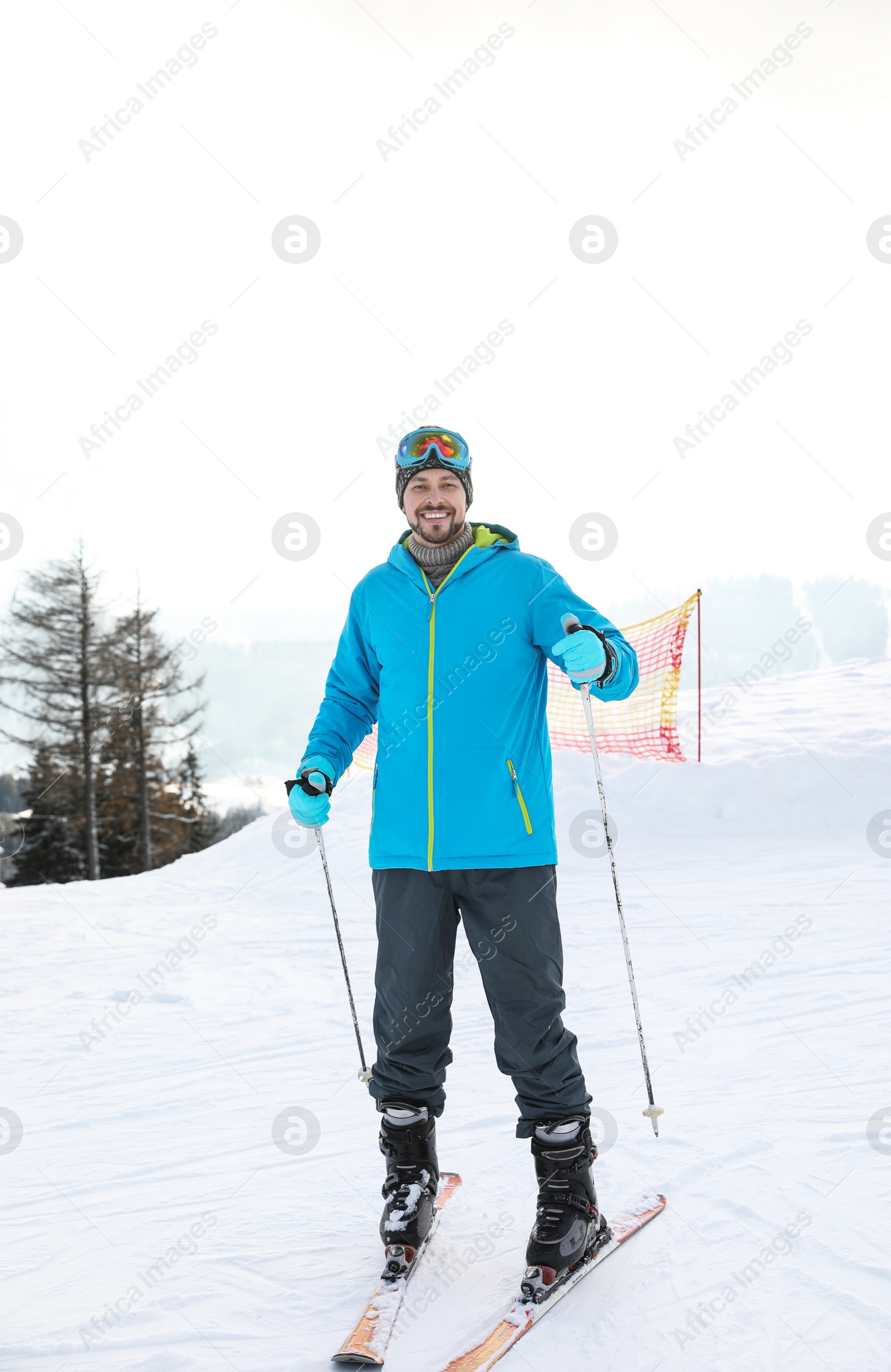 Photo of Man with ski equipment spending winter vacation at mountain resort