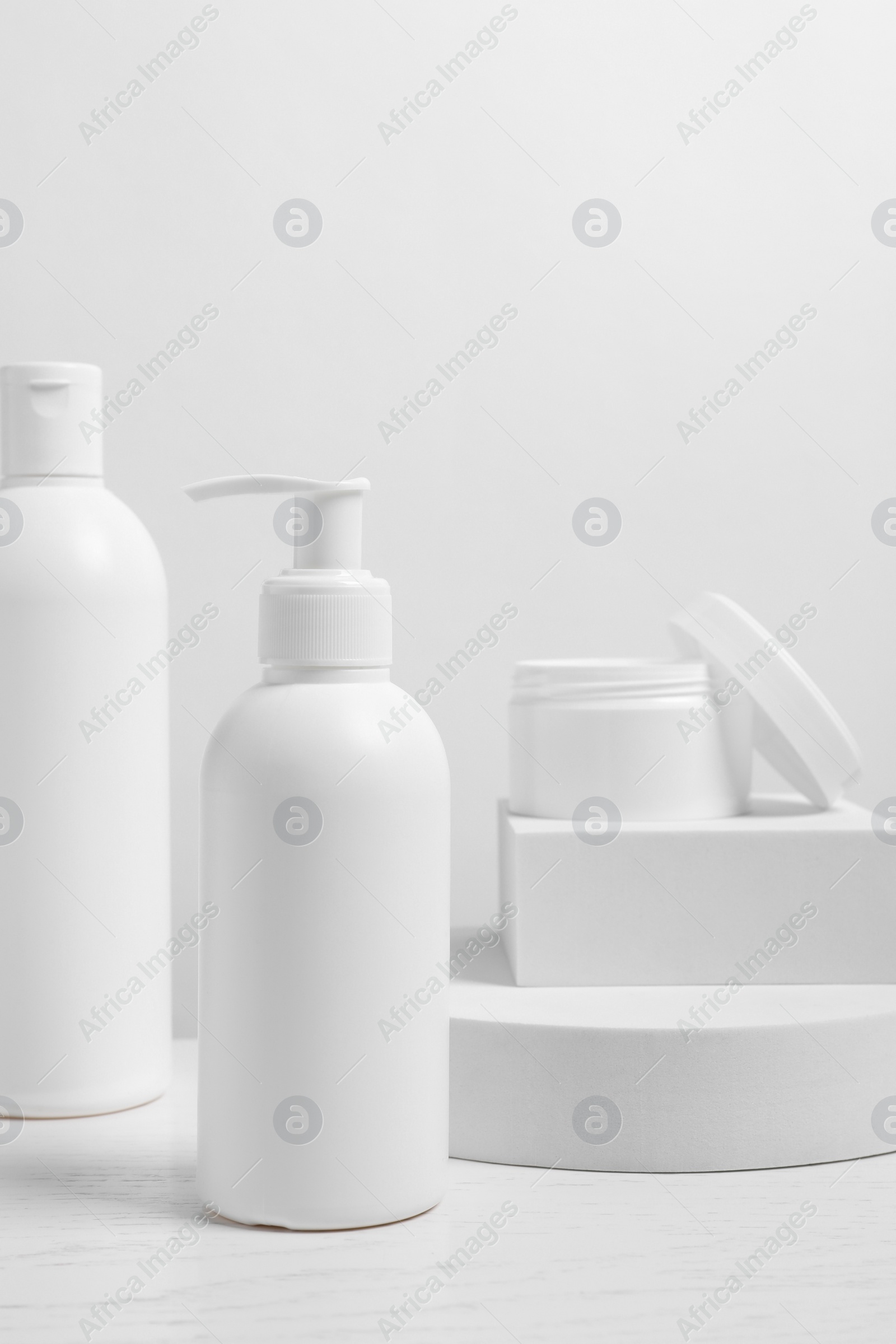 Photo of Different cosmetic products on white wooden table