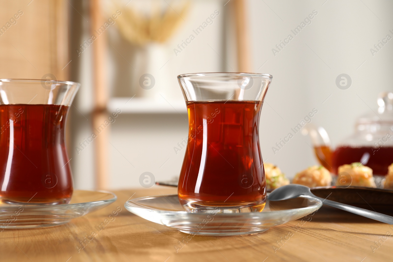 Photo of Traditional Turkish tea in glasses on wooden table