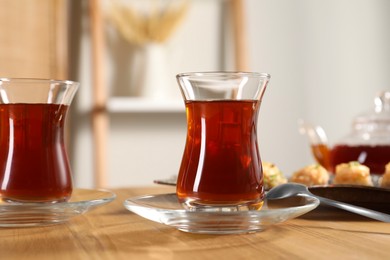 Traditional Turkish tea in glasses on wooden table