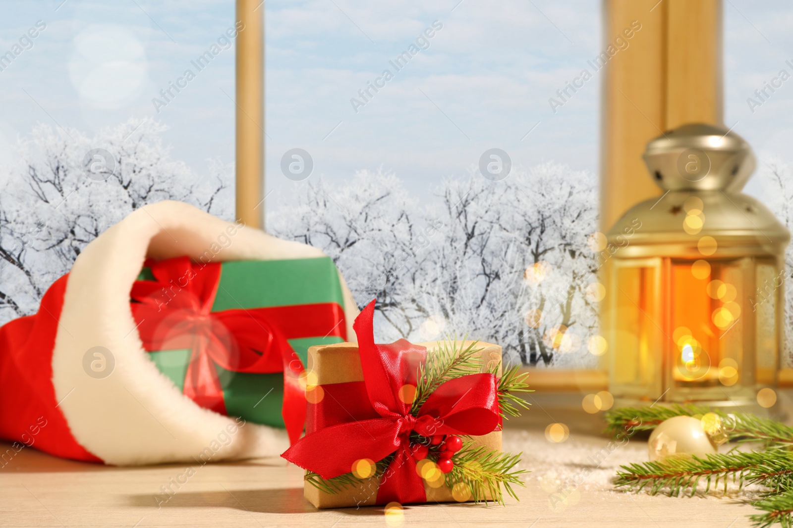 Image of Gift boxes and festive decor on window sill indoors. Christmas eve