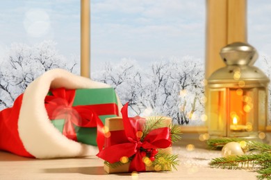 Image of Gift boxes and festive decor on window sill indoors. Christmas eve
