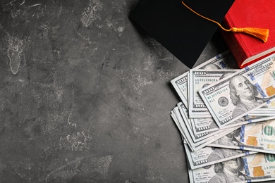 Photo of Flat lay composition with dollars and student graduation hat on stone background, space for text. Tuition fees concept