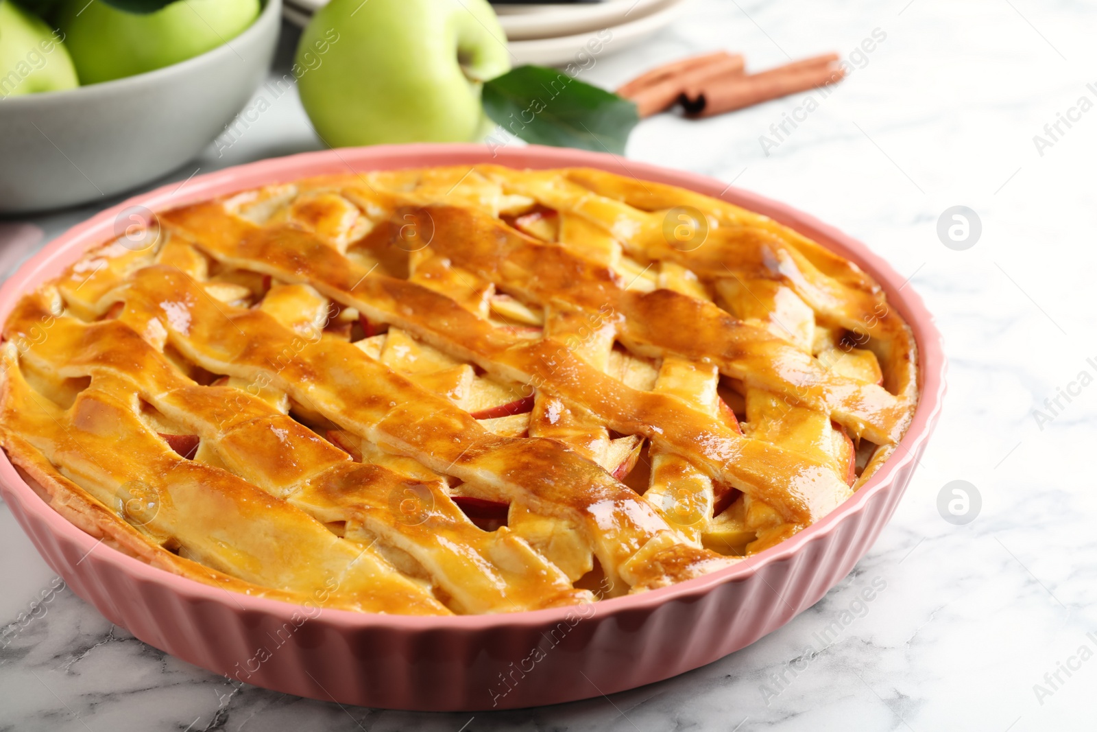 Photo of Fresh traditional apple pie on white marble table