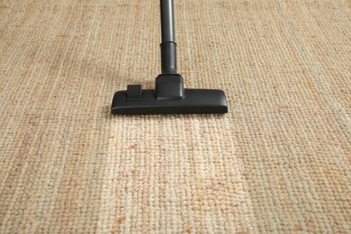 Hoovering carpet with vacuum cleaner. Clean trace on dirty surface