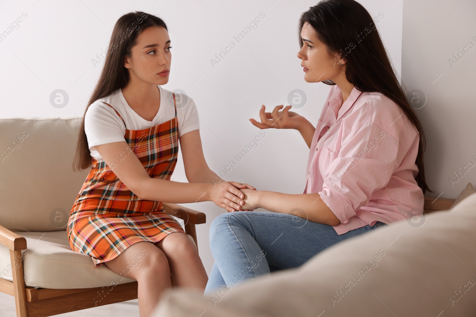 Photo of Professional psychologist working with young woman in office