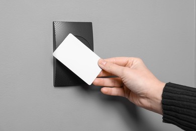 Photo of Woman opening magnetic door lock with key card, closeup. Home security