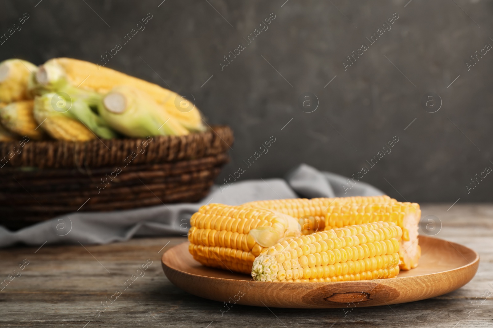 Photo of Plate with tasty sweet corn on wooden table